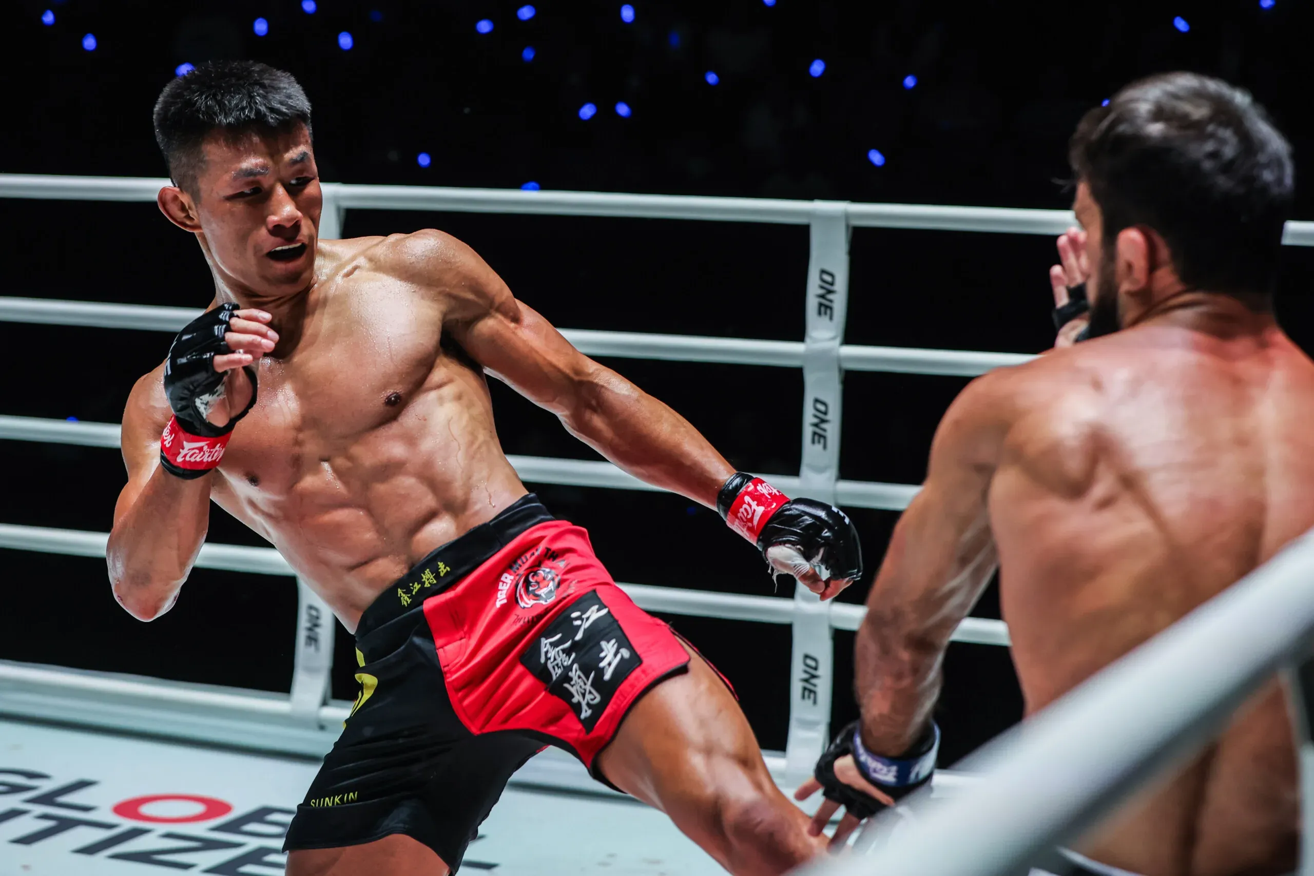 Chinese MMA fighter Tang Kai lands a calf kick on Shamil Gasanov