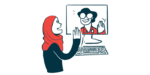 A woman greets a doctor seen on a computer screen during a telemedicine visit.