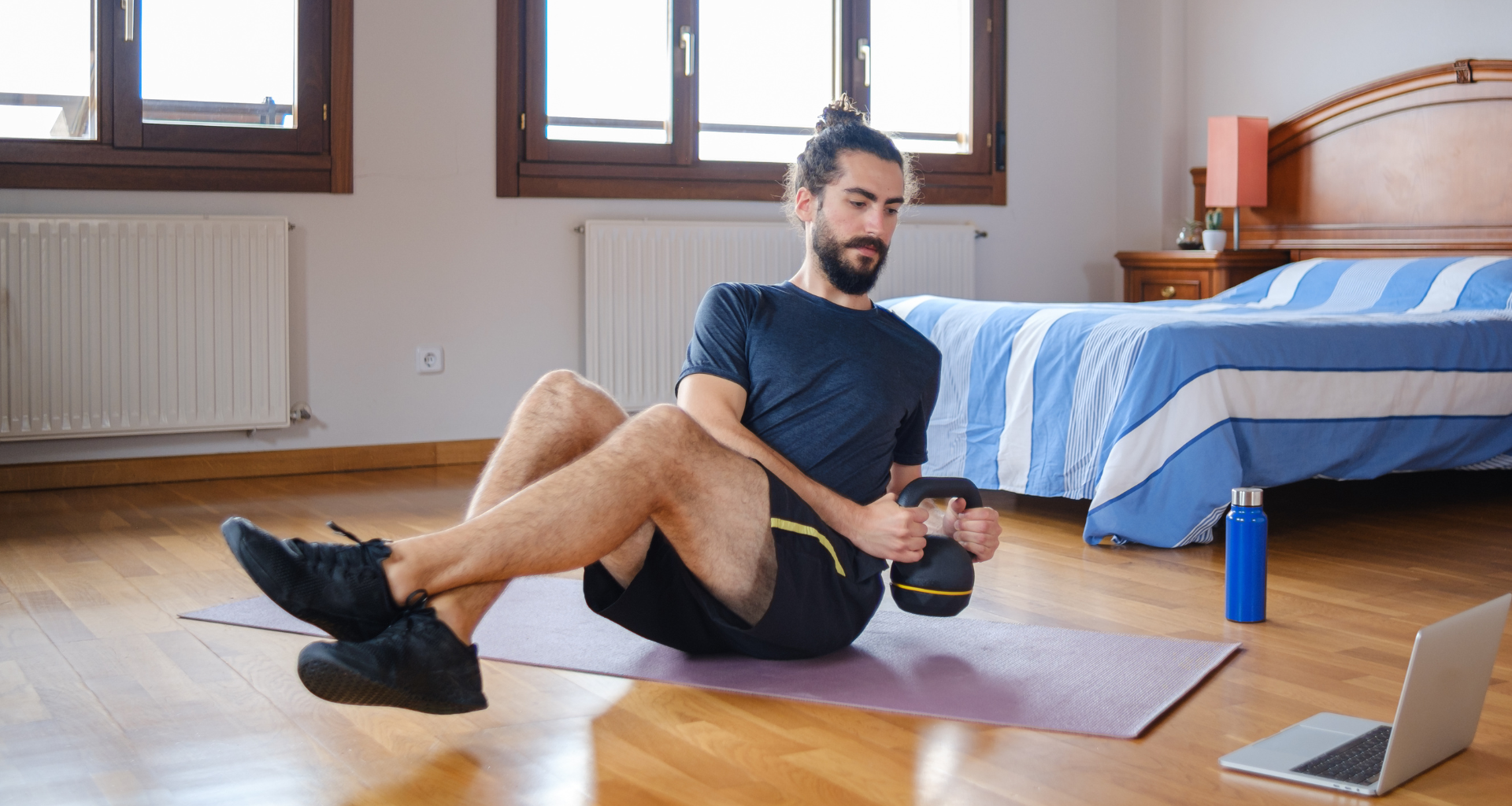 Man doing kettlebell Russian twist exercise
