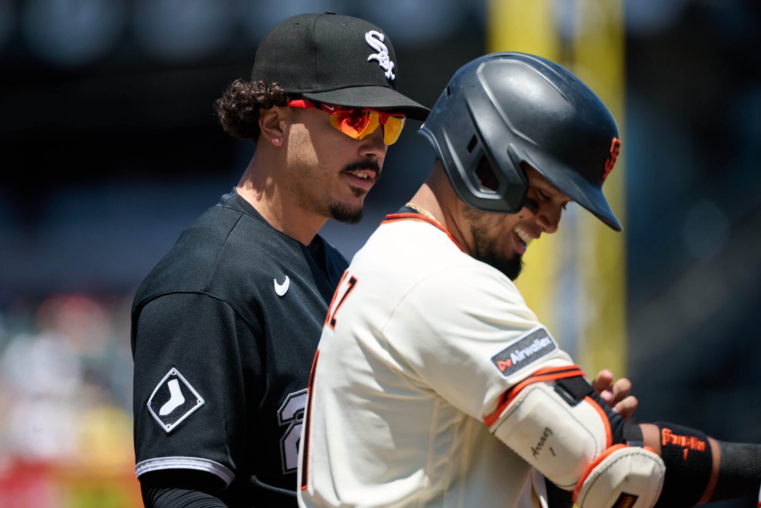 May 24, 2026; San Francisco, California, USA; San Francisco Giants infielder Luis Arraez (1) talks with Chicago White Sox infielder Miguel Vargas (20) at first base after being hit by a pitch during the third inning at Oracle Park.