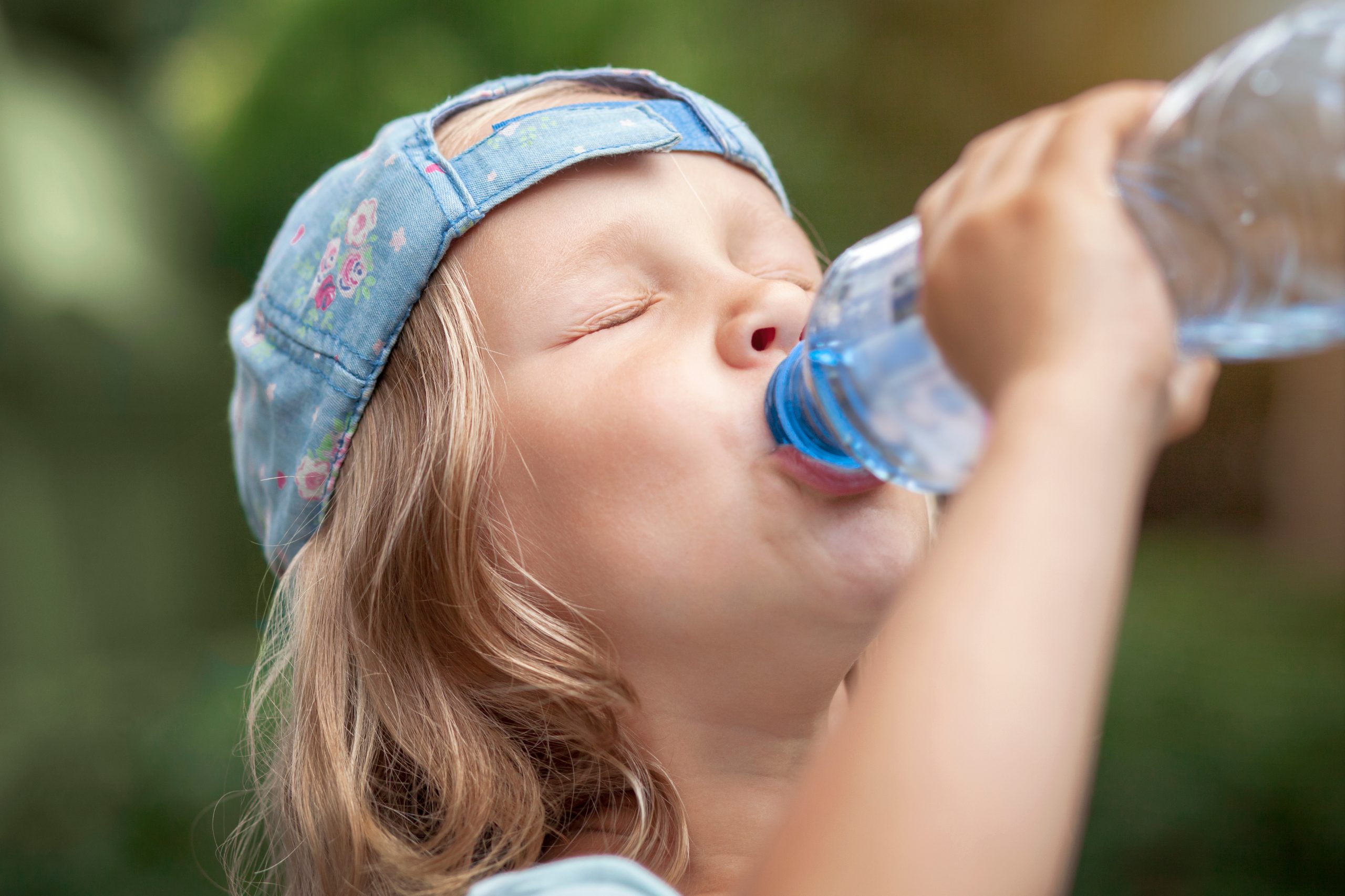 Child drinking water from a water bottle
