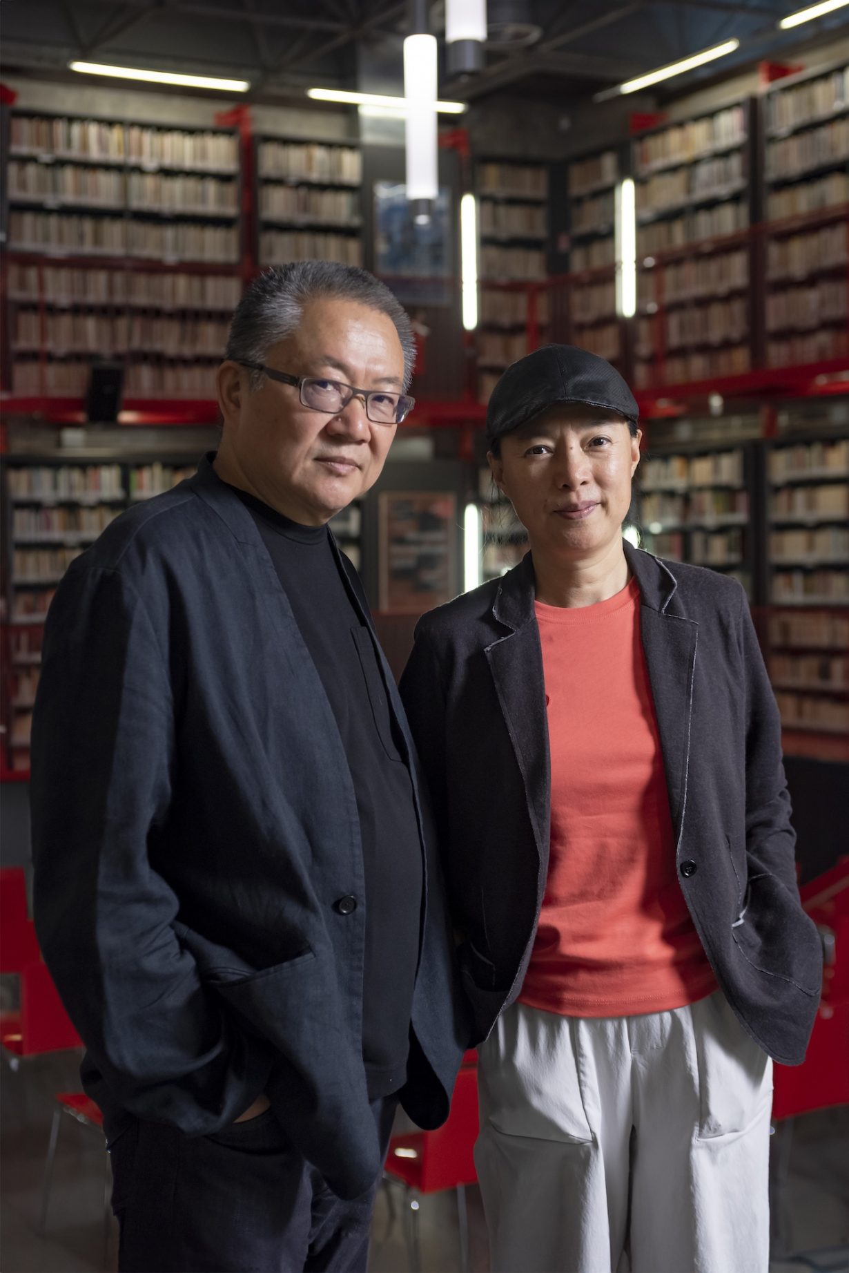 Wang Shu and Lu Wenyu standing in a library