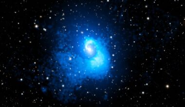 A blue spirally blob in the middle of a starry sky.