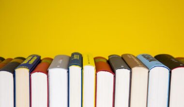 A series of books stacked horizontally so we only see the bottom of their pages with a bright yellow background behind.
