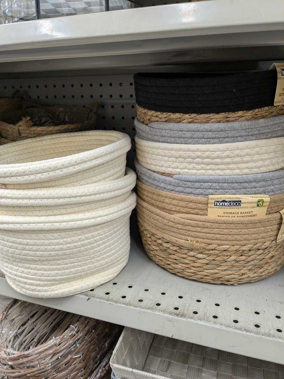 A shelf with stacks of woven decorative baskets