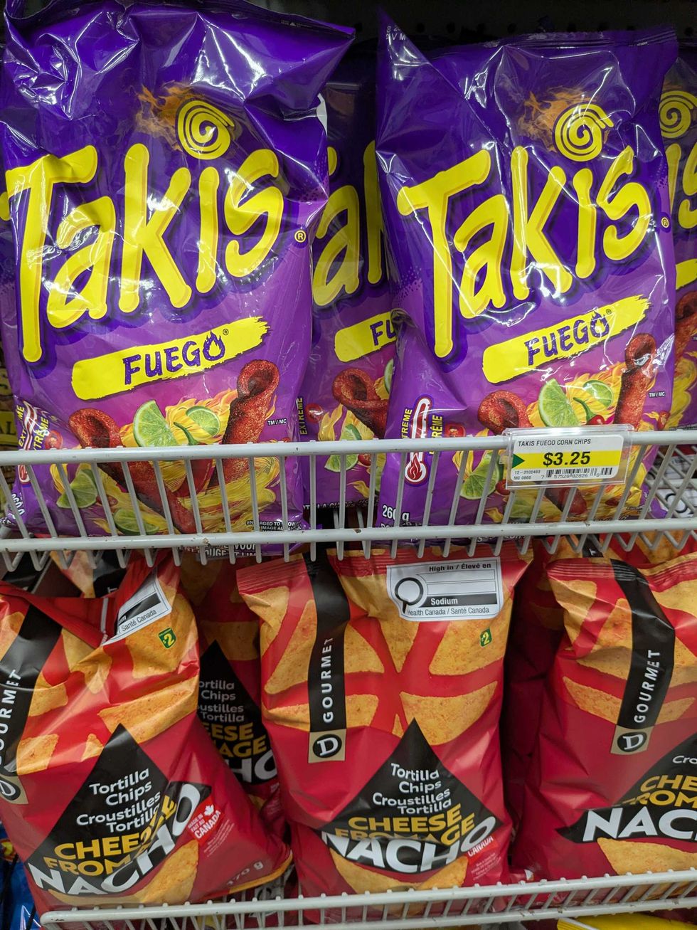 A shelf with Takis and Dollarama brand chips