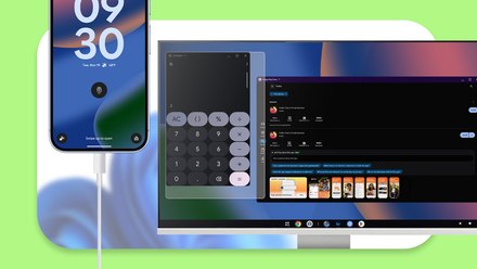 A smartphone connected to a monitor displaying an Android desktop interface with floating windowed apps.