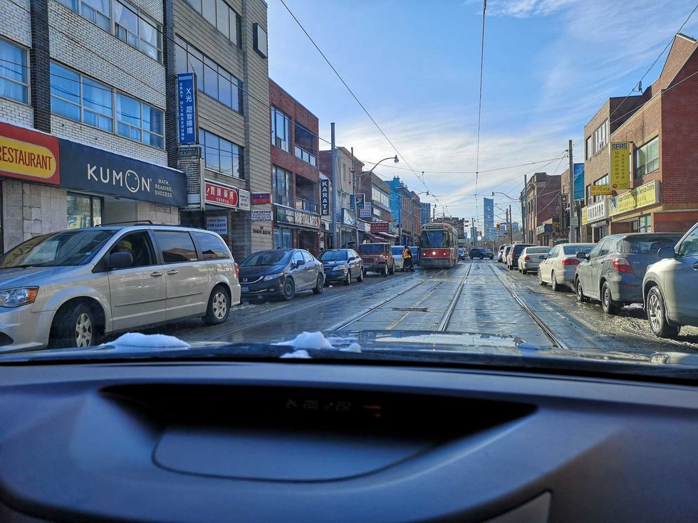 a toronto street from inside of a car