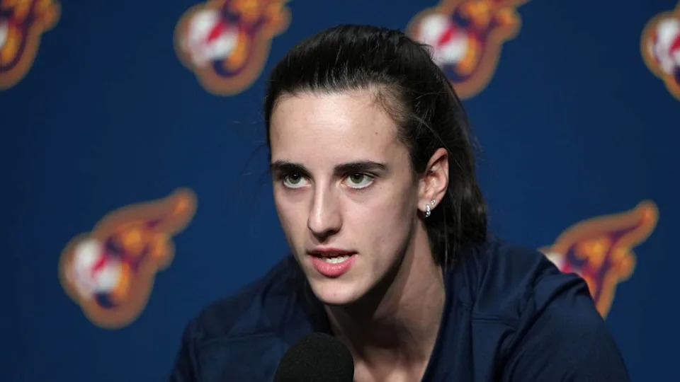 Indiana Fever guard Caitlin Clark (22) talks to media members before a game.Darren Yamashita-Imagn Images