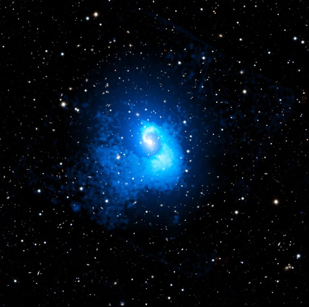 Abell 2029 is a large galaxy cluster that contains more than 1,000 galaxies. It's one of the large clusters we know of and appears to be calm and relaxed. But Chandra x-ray observations reveal evidence of a massive merger event about 4 billion years ago. Image Credit: X-ray: NASA/CXC/CfA/C. Watson et al.; Optical: PanSTARRS; Image Processing: NASA/CXC/SAO/N. Wolk and P. Edmonds