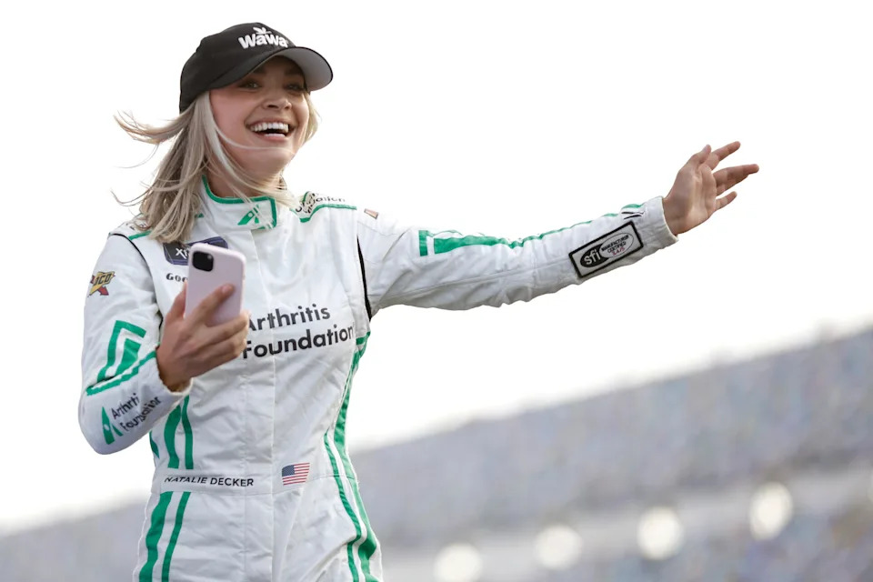 Natalie Decker, driver of the #53 Wawa Rechargers Ford, waves to fans as she walks onstage.