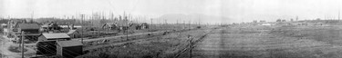 1911: Kerrisdale at 41st Avenue and West Boulevard. The panoramic view shows the post office, a B.C. Electric railway car, C.P.R. gardens and stables.