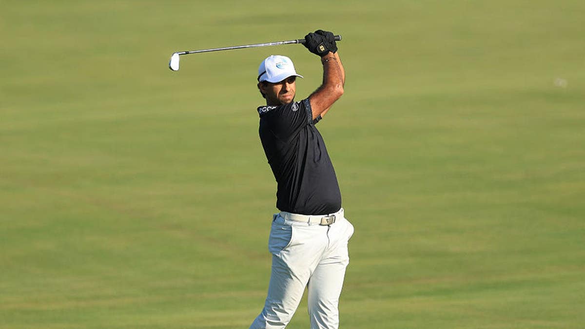 Aaron Rai of England hits an iron