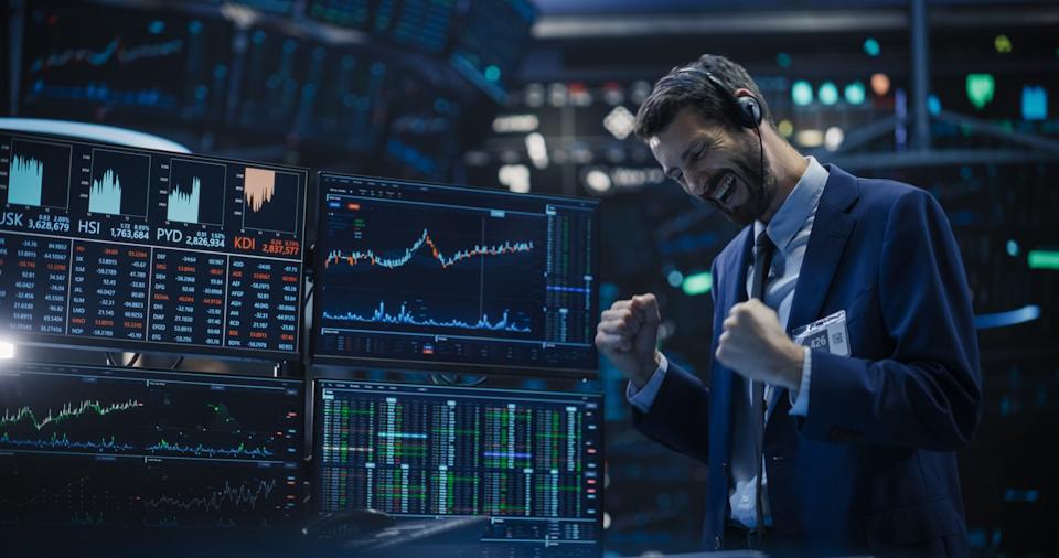 An investor celebrating on the floor of the New York Stock Exchange.