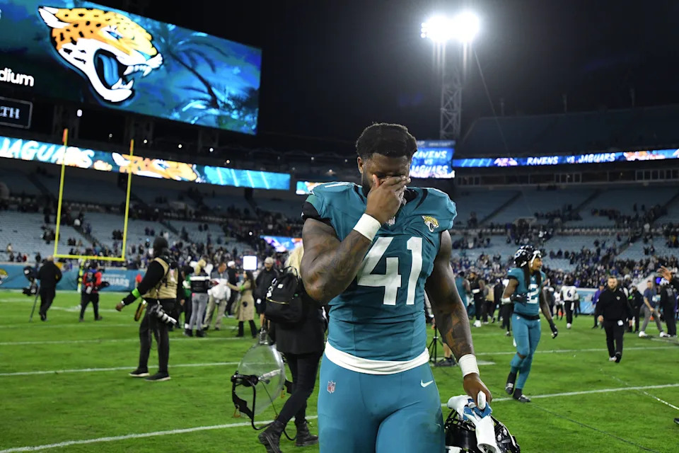 Jacksonville Jaguars linebacker Josh Allen (41) wipes his face as he walks off the field after Sunday night's loss to the Ravens