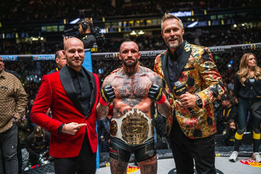 Eckerlin alongside OKTAGON owners after being crowned King of Germany after his win in Frankfurt.