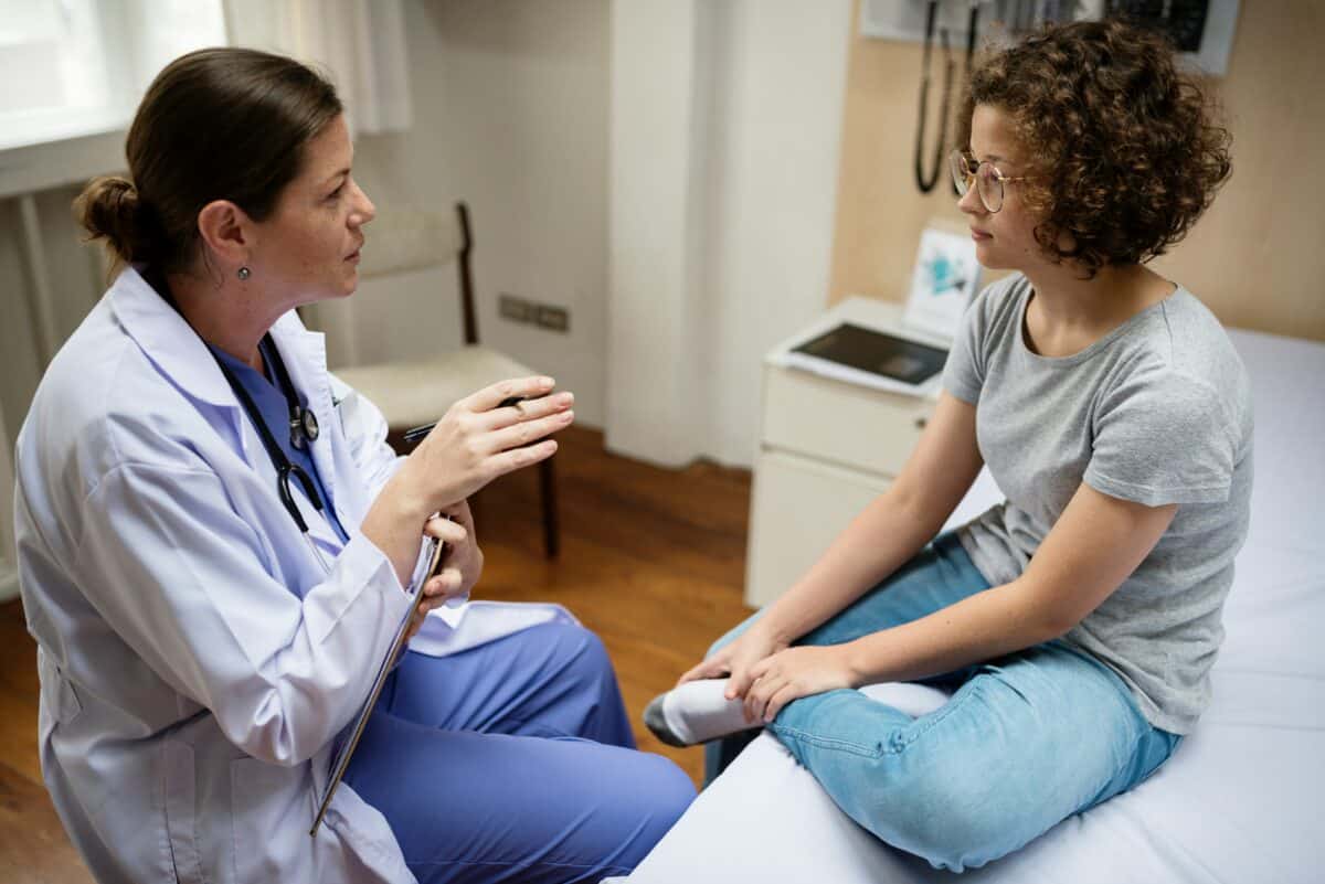 adolescent with doctor
