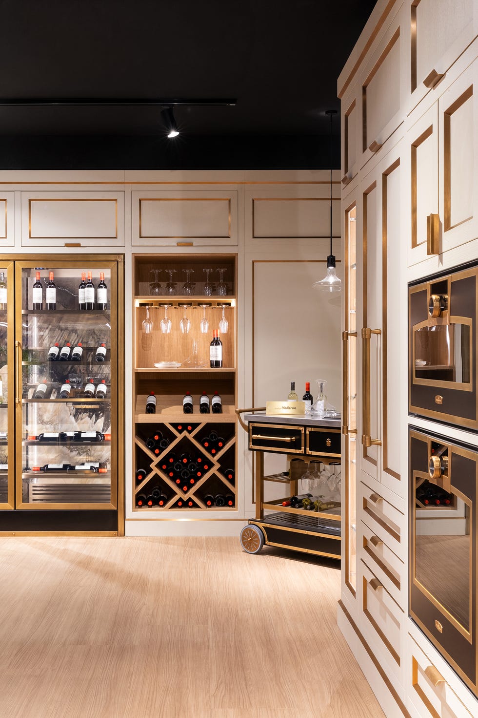 Stylish wine storage and preparation area with cabinetry and appliances.