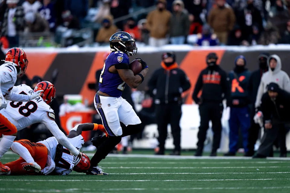 Baltimore Ravens running back Derrick Henry (22) runs by Cincinnati Bengals linebacker Demetrius Knight Jr. (44).