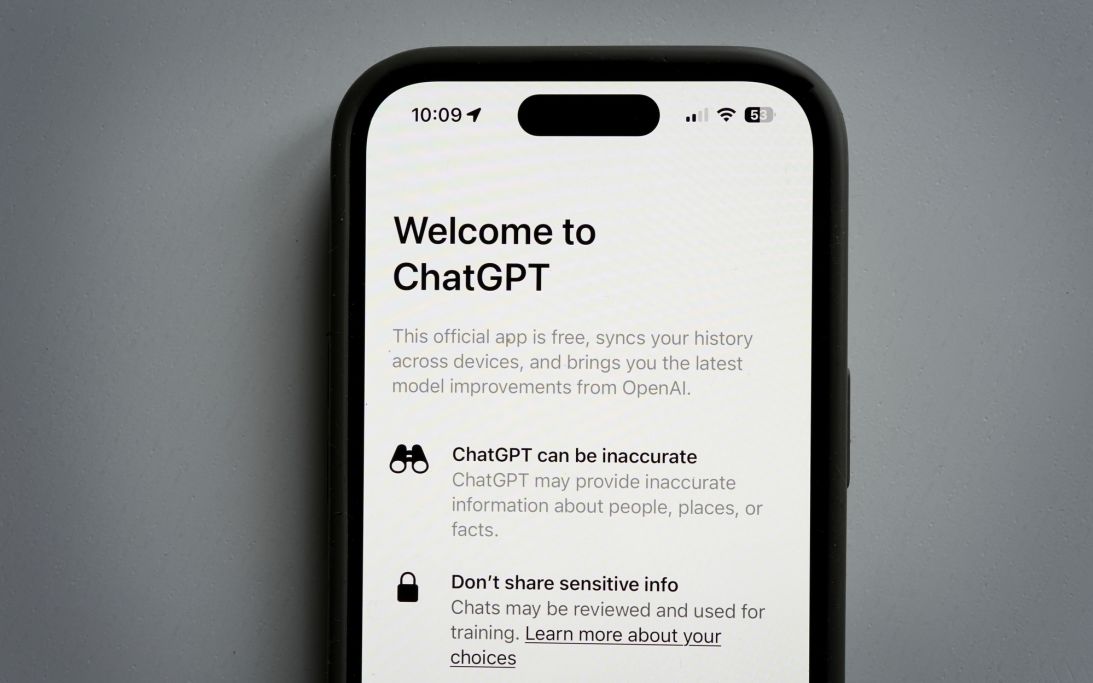 A file photo depitcts a mobile phone displaying the welcome screen to the ChatGPT app.