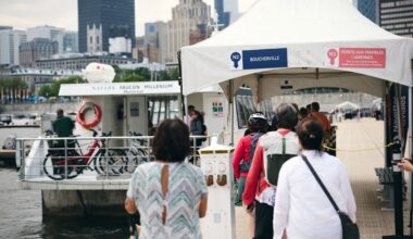People line up on a port wharf for a boat shuttle.