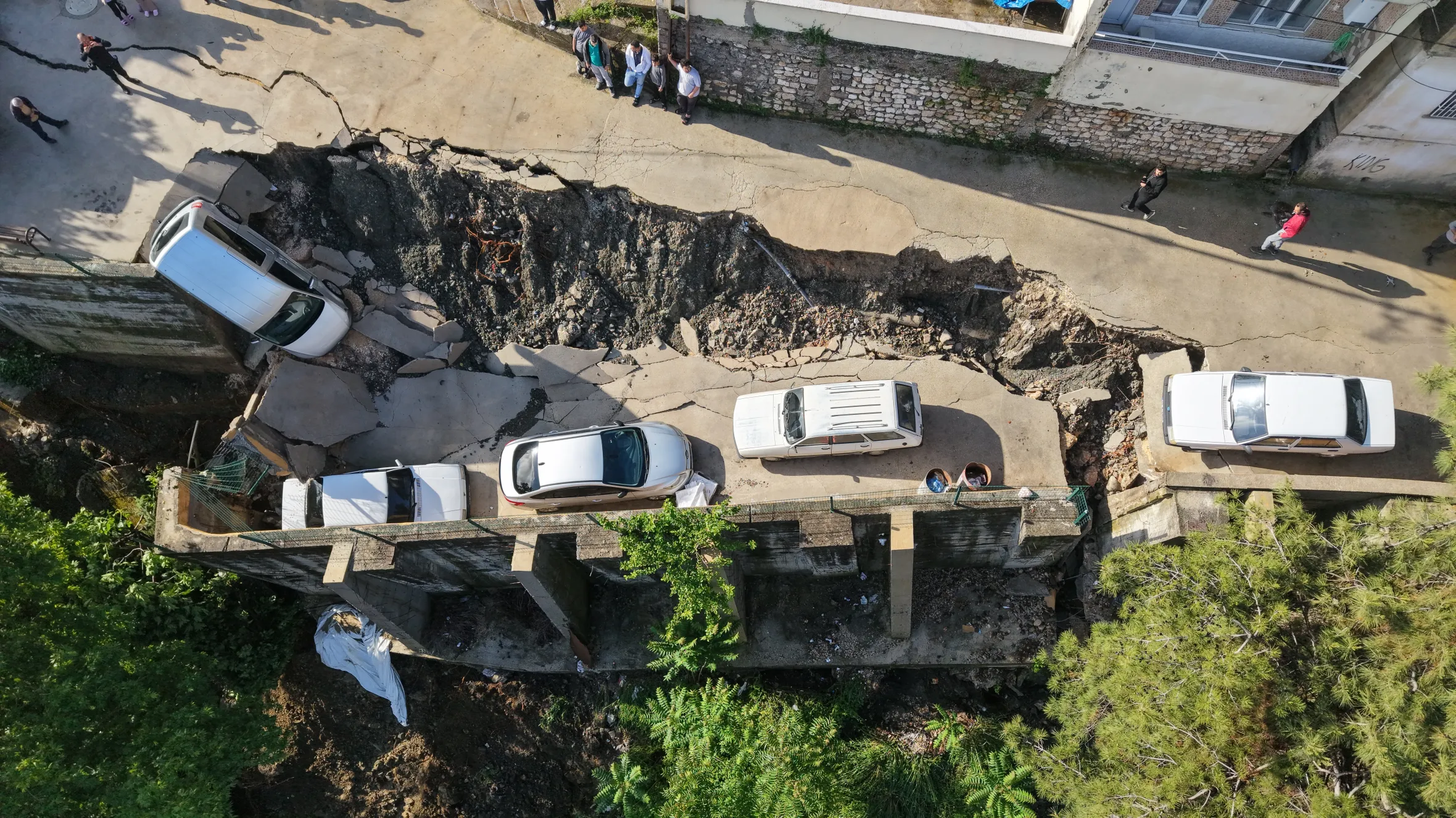 Aerial view of the collapsed Karacay Bridge with five damaged cars.