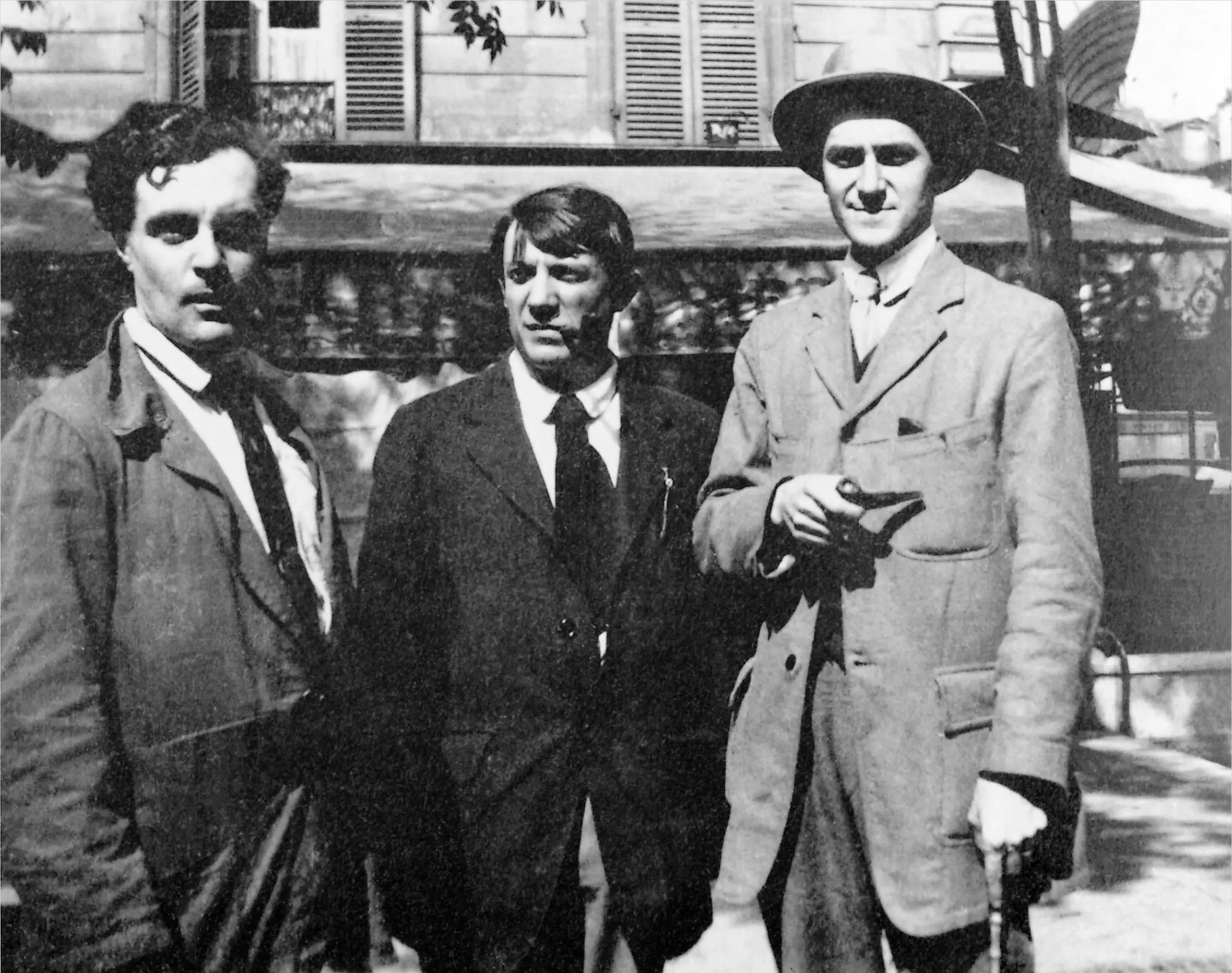 Amedeo Modigliani, Pablo Picasso, and Andre Salmon standing together outdoors.