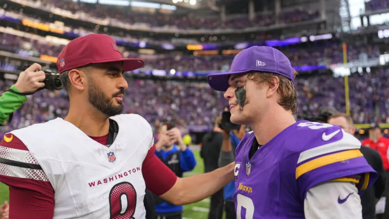 J.J. McCarthy speaks with Marcus Mariota after a game at U.S. Bank Stadium. Vikings QB room