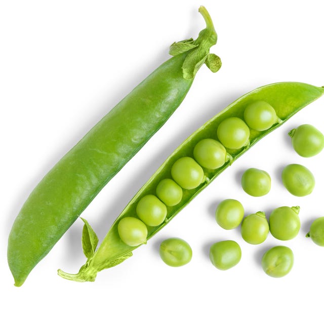 Open pea pod with green peas isolated on white background, healthy vegetables for diet and recipes open green pea pod with individual peas scattered around, isolated on white background. image ideal for food related designs, healthy lifestyle, and organic products legume, crop, food ingredient