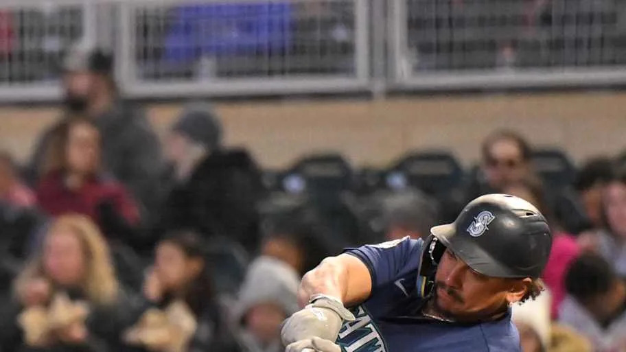 Seattle Mariners infielder Josh Naylor (12) hits an RBI single against the Minnesota Twins