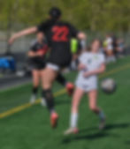 Juneau-Douglas High School: Yadaa.at Kalé sophomore Gracie Snyder (22) deflects a ball past Service freshman Taylyn Reed (9) during the Crimson Bears’ 4-0 win over the Cougars in the consolation semifinals of the ASAA girls Soccer State Championships at Colony on Friday, May 29, 2026. (Klas Stolpe / Juneau Independent)
