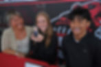 JDHS senior Peyton Wheeler face-timed good friend Milina Mazon after signing a letter of intent Monday, May 18, 2026, in the JDHS commons to attend Peninsula College in Port Angeles, Washington, and play soccer for the Pirates. From left are Heidi Mazon, Milina Mazon (on phone), Peyton Wheeler and Sam Mazon. (Klas Stolpe / Juneau Independent)