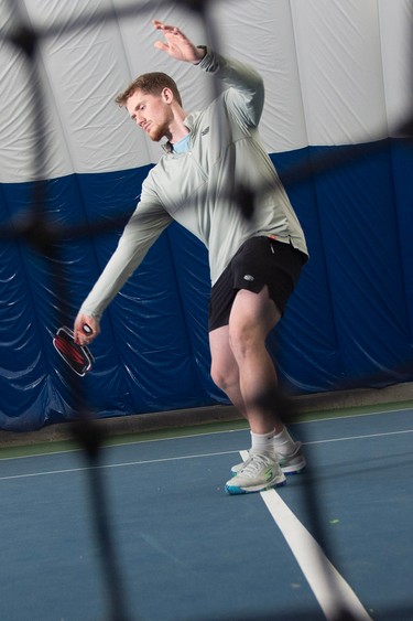 David Summers pictured playing pickleball behind a net.