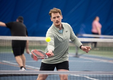 David Summers hitting a ball with a racket during a game of pickleball.