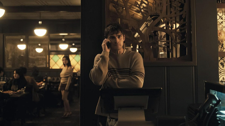 Bear on the phone while Nikki lurks in the background in Obsession