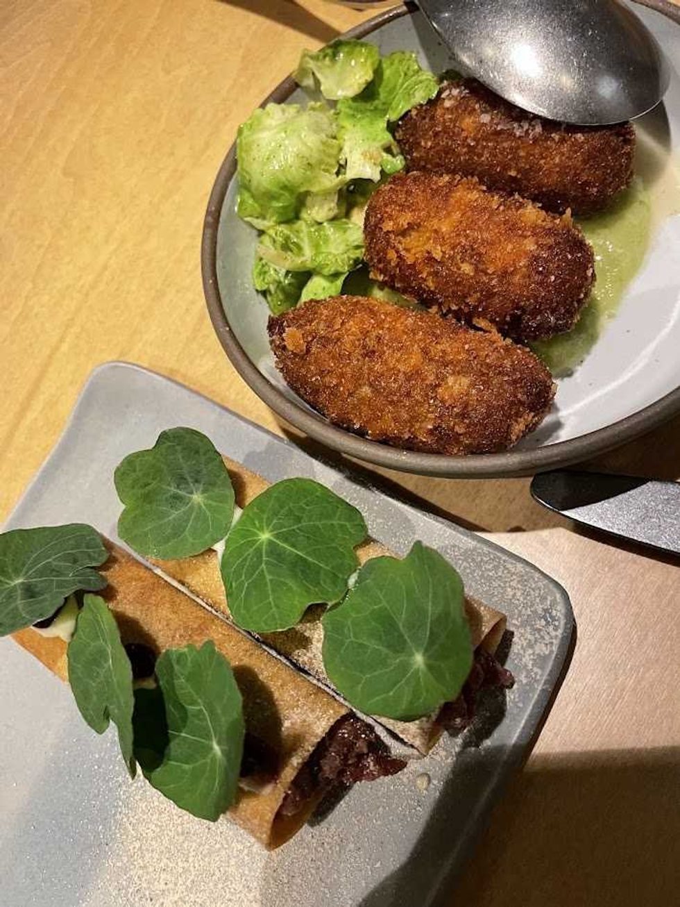Beef tartare and croquettes de cretons on small grey plates at Buvette Daphn\u00e9e