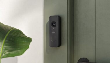 Blink's new battery doorbell on a gray door frame.