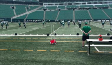 Saskatchewan Roughriders players are spread across the field during the final day of training camp at Mosaic Stadium in Regina. Coaches observe from the sideline as players participate in drills ahead of final roster cuts.