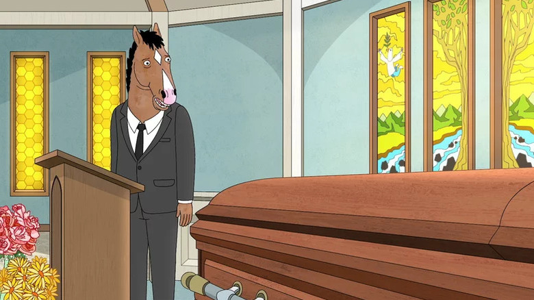 BoJack Horseman wearing a suit and standing next to a coffin