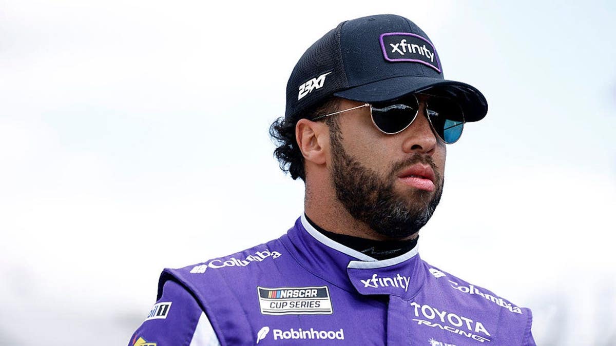 Bubba Wallace standing on pit road at Dover Motor Speedway