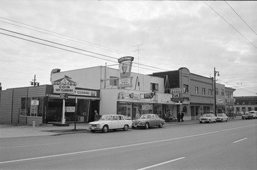 1968: A view west down the south side of the 2000 block of West 41st Avenue. Visible are Carlton's Coin Laundry, Ernie's Kentucky Fired Chicken and Granville Market.