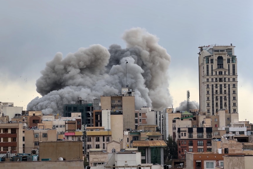 A plume of smoke rises after a strike in Tehran,