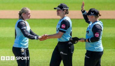 Surrey's Ryana MacDonald-Gay (left) celebrates a wicket with teammates