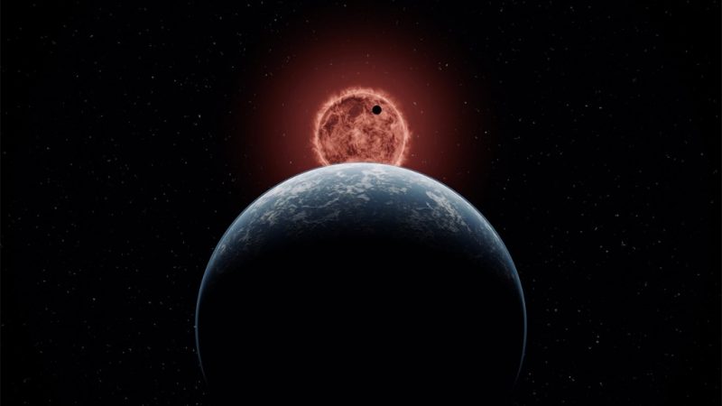 Large blue planet seen from behind, with smaller planet crossing a red sun-like star.