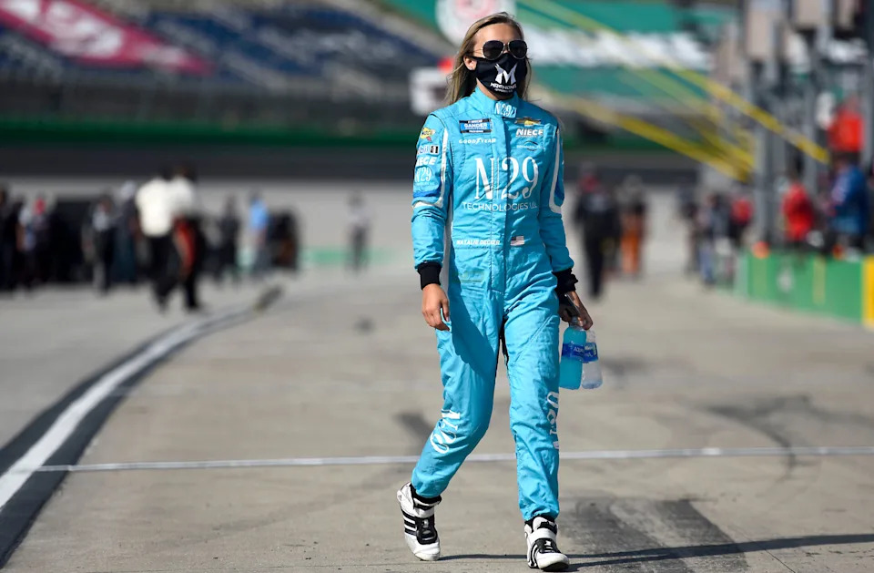 Natalie Decker, driver of the #44 N29 Capital Partners Chevrolet, walks on the grid prior to the NASCAR Gander RV & Outdoors Truck Series Buckle Up In Your Truck 225 at Kentucky Speedway.