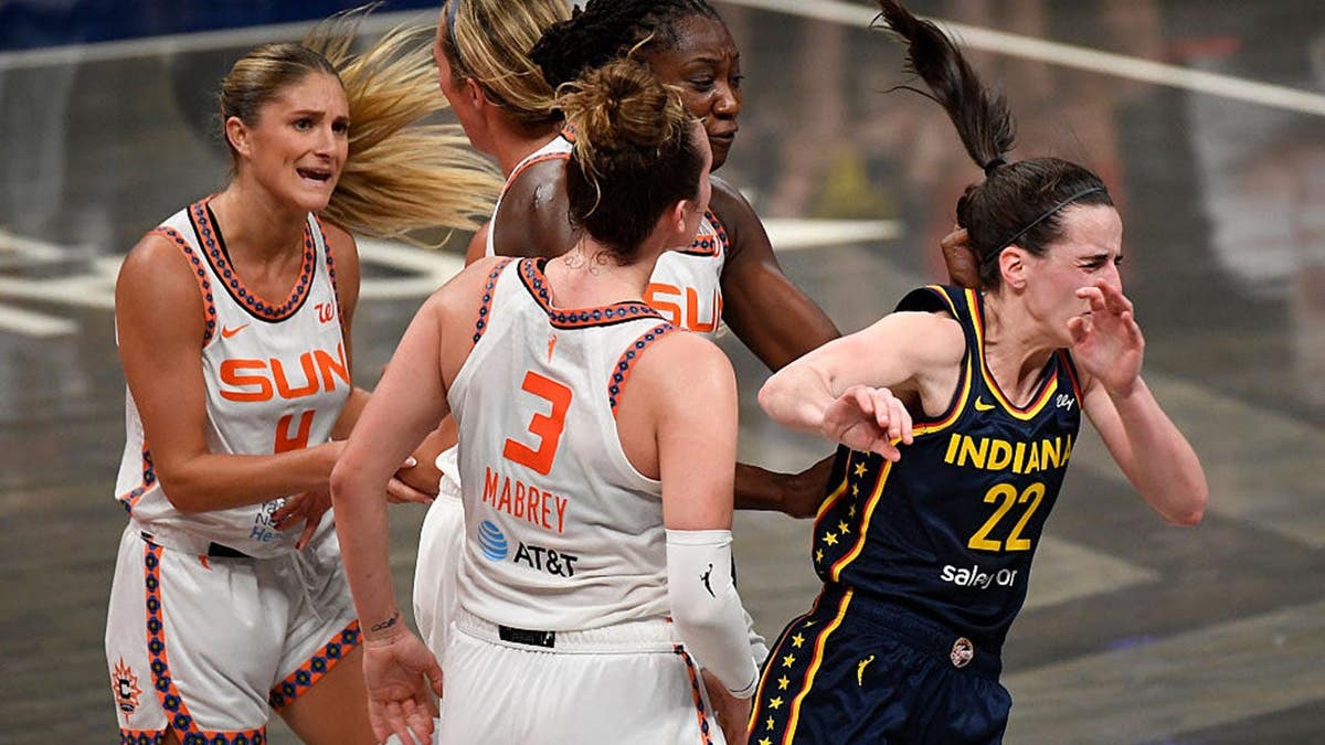 Indiana Fever guard Caitlin Clark reacting after being shoved during a WNBA game