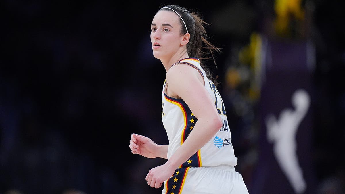 Indiana Fever guard Caitlin Clark jogging up the basketball court.