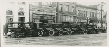 1918: Fleet of Calladines Grocery trucks and view of 2300 block Main Street between 7th and 8th Avenues.