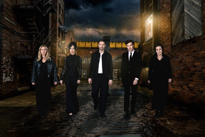 Coronation Street murder week promo artwork Megan, Jodie, Carl, Theo and Maggie - dressed in funeral attire - walk down Victoria Street in key art for Coronation Street's murder week