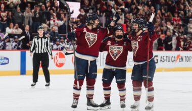 Three Victoire players celebrate on the ice.